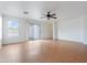 Bright living room with sliding glass doors, neutral paint, wood-look floors, and a ceiling fan at 2323 W Carson Rd, Phoenix, AZ 85041