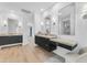 Bright bathroom featuring dual vanities, modern lighting, and sleek black cabinetry at 24417 N 87Th St, Scottsdale, AZ 85255