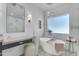 Bathroom featuring a modern tub, glass shower, and sleek vanity at 24417 N 87Th St, Scottsdale, AZ 85255