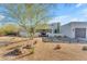 Elegant stucco house with beautiful desert landscaping and mature tree in a bright, sunny setting at 24417 N 87Th St, Scottsdale, AZ 85255