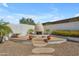 Exterior courtyard showcasing a unique fireplace, desert landscaping, and a tranquil ambiance at 24417 N 87Th St, Scottsdale, AZ 85255