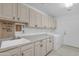 Functional laundry room with shaker-style cabinets, a sink, and modern washer and dryer at 24417 N 87Th St, Scottsdale, AZ 85255