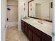 Well-lit bathroom featuring a large vanity and tub-shower combo at 25879 W Elizabeth Ave, Buckeye, AZ 85326