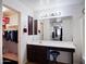 Bright bathroom featuring a white vanity with dark wood cabinets and a walk-in closet at 25879 W Elizabeth Ave, Buckeye, AZ 85326