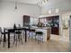 Open kitchen with dark wood cabinetry, dining area, and modern lighting at 25879 W Elizabeth Ave, Buckeye, AZ 85326