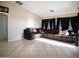 Spacious living room with sectional sofa and tile flooring at 25879 W Elizabeth Ave, Buckeye, AZ 85326