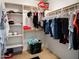 Organized walk-in closet with shelves and hanging racks for clothing storage solutions at 25879 W Elizabeth Ave, Buckeye, AZ 85326