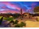 Backyard putting green with patio, fireplace, and desert sunset backdrop at 30600 N Pima Rd # 49, Scottsdale, AZ 85266