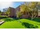 Backyard area featuring a lush lawn, mature trees, and outdoor seating at 30600 N Pima Rd # 49, Scottsdale, AZ 85266