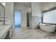 Bathroom featuring a soaking tub, glass shower, and elegant fixtures at 30600 N Pima Rd # 49, Scottsdale, AZ 85266