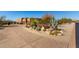 Long driveway leading to a Southwestern-style home surrounded by desert landscaping at 30600 N Pima Rd # 49, Scottsdale, AZ 85266