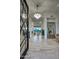 Grand foyer with wood-look tile floors, a crystal chandelier, and an ornate front door at 30600 N Pima Rd # 49, Scottsdale, AZ 85266