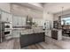 Well-lit kitchen featuring stainless steel appliances, stylish cabinets, and an island with granite countertop at 30600 N Pima Rd # 49, Scottsdale, AZ 85266