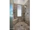 Modern tiled shower featuring glass block window, mosaic floor, seat, and rainfall shower head at 30600 N Pima Rd # 49, Scottsdale, AZ 85266