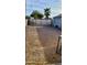 Gated lot featuring crushed stone and palm trees in the backyard at 3133 W Polk St, Phoenix, AZ 85009