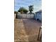 A large metal fence enclosing a backyard under construction at 3133 W Polk St, Phoenix, AZ 85009