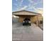 Exterior shot of a home with a carport showing a front view of the car parked beneath it at 3133 W Polk St, Phoenix, AZ 85009