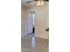 Hallway with tiled flooring featuring door and bright natural light at 3133 W Polk St, Phoenix, AZ 85009