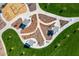 Aerial view of a neighborhood park featuring picnic areas, playgrounds, and walking paths at 3741 W Poinsettia Dr, Phoenix, AZ 85029