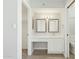 En-suite bathroom with white double sink vanity and mirrors, bright lighting, and private toilet and closet at 4634 W Aire Libre Ave, Glendale, AZ 85306