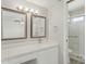 Bright bathroom featuring double vanity, granite countertops, and a glass-enclosed shower at 4634 W Aire Libre Ave, Glendale, AZ 85306