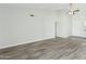 Spacious living room with wood-look flooring, high ceilings, and a ceiling fan at 4634 W Aire Libre Ave, Glendale, AZ 85306