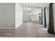 Open floor plan showcases the neutral paint palette and wood-look tile flooring leading into the kitchen at 4634 W Aire Libre Ave, Glendale, AZ 85306