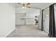 View of bright kitchen, neutral paint, wood-look tile flooring, and sliding glass doors to outdoor space at 4634 W Aire Libre Ave, Glendale, AZ 85306