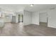 Bright living room features neutral paint, wood-look tile flooring, and open plan leading to kitchen and dining at 4634 W Aire Libre Ave, Glendale, AZ 85306