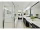 A bright bathroom featuring a double vanity, glass-enclosed shower, and a luxurious soaking tub at 4777 S Fulton Ranch Blvd # 1103, Chandler, AZ 85248