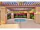 Community hot tub with pergola offering a relaxing space surrounded by lush greenery at 4777 S Fulton Ranch Blvd # 1103, Chandler, AZ 85248