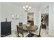 Open-concept dining area with views into the kitchen and stairway, featuring a wooden table and modern light fixture at 4777 S Fulton Ranch Blvd # 1103, Chandler, AZ 85248