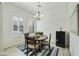 Bright dining area features plantation shutters, a modern chandelier, and a table set for four, creating an inviting space at 4777 S Fulton Ranch Blvd # 1103, Chandler, AZ 85248