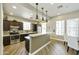 Modern kitchen featuring stainless steel appliances, dark wood cabinets, and a breakfast bar at 4777 S Fulton Ranch Blvd # 1103, Chandler, AZ 85248