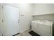 Functional laundry room with a washer and dryer, offering ample storage and convenience, adjacent to the garage entry at 4777 S Fulton Ranch Blvd # 1103, Chandler, AZ 85248