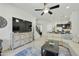 Open-concept living room with modern decor, ceiling fan, and adjacent staircase to the second floor at 4777 S Fulton Ranch Blvd # 1103, Chandler, AZ 85248