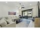 Bright living room with neutral furniture, a ceiling fan, and sliding glass doors to the outdoors at 4777 S Fulton Ranch Blvd # 1103, Chandler, AZ 85248