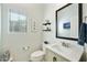 Bright powder room with a modern vanity, decorative mirror, and window, offering a fresh and clean aesthetic at 4777 S Fulton Ranch Blvd # 1103, Chandler, AZ 85248