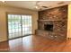 Cozy living room with brick fireplace and sliding door with pool view at 511 W Ocotillo Rd, Phoenix, AZ 85013