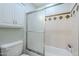 Bathroom featuring a tub with sliding glass door and overhead storage at 516 E Gemini Dr, Tempe, AZ 85283