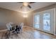 Bright dining area featuring a ceiling fan and glass doors leading to the backyard at 516 E Gemini Dr, Tempe, AZ 85283