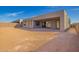 The backyard has modern stucco, desert landscaping, and a covered patio at 5724 E Moura Dr, Cave Creek, AZ 85331