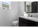 Bright bathroom featuring a black framed mirror, sleek vanity, and contemporary fixtures at 5724 E Moura Dr, Cave Creek, AZ 85331