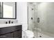 Modern bathroom featuring glass shower with dark hardware, floating vanity, and neutral color palette at 5724 E Moura Dr, Cave Creek, AZ 85331