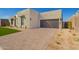 Contemporary home with desert landscaping, paved driveway, and a sleek, modern garage door at 5724 E Moura Dr, Cave Creek, AZ 85331