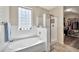 Bright bathroom featuring a soaking tub, stand-up shower and a window at 6523 S 34Th Dr, Phoenix, AZ 85041