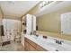 Bright bathroom features dual sinks, a large mirror, and a shower-tub combo with stylish tile at 6523 S 34Th Dr, Phoenix, AZ 85041