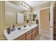 Well-lit bathroom featuring double sinks, a large mirror, and neutral decor for a serene experience at 6523 S 34Th Dr, Phoenix, AZ 85041