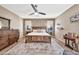 Warm bedroom featuring natural light, wooden furniture, and a ceiling fan at 6523 S 34Th Dr, Phoenix, AZ 85041