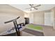 Bright workout room features carpet, workout bench, and treadmill for convenient at home fitness at 6523 S 34Th Dr, Phoenix, AZ 85041